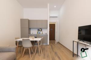 a kitchen and a living room with a table and chairs at Collegno Cozy Apartments in Turin +61 photos