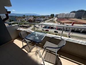 a balcony with a table and chairs and a train at Serenity Apartment in Struga