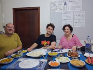 a group of people sitting around a table with food at SILVER RAIL in Galle +64 photos