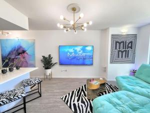 a living room with a couch and a tv at Electric Luxury Downtown Bayfront Brickell in Miami