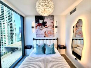 a bedroom with a bed and a large window at Electric Luxury Downtown Bayfront Brickell in Miami