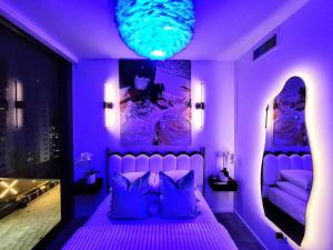 a purple bedroom with a bed with purple lighting at Electric Luxury Downtown Bayfront Brickell in Miami