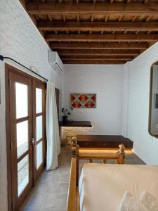 a room with a wooden door and a table at Apollino Lindos in Lindos