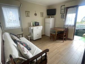 a living room with a couch and a table at La Casina de L'Aspu in Luces