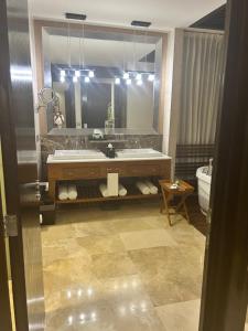 a bathroom with a sink and a large mirror at 2 bedroom luxury apartment in Nuevo Nayarit