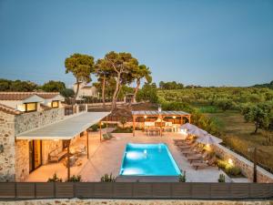 an aerial view of a villa with a swimming pool at Alestone Villa by the sea in Vasilikos