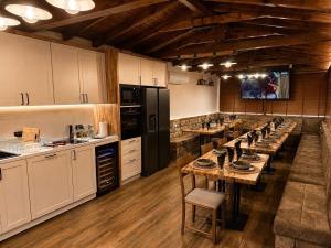 a large kitchen with a long table in it at Forest Hills in Kovačevica