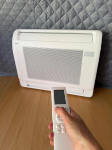 a person holding a remote control in front of a computer at Ursa Camp Mountain Glamping in Gornje Lipovo