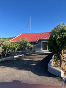 a house with a red roof and some trees at Suf Hills Cabin in Jerash