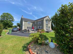 a house with a car parked in front of it at Room Stay 4 in Corran Cross Roads +3 photos
