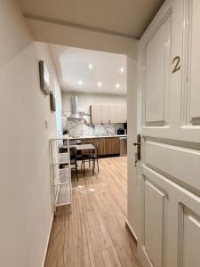 an open door to a kitchen with a dining table at Sliema Arch Suites Modern Boutique Apartment in St. Julianʼs