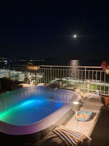a swimming pool on the deck of a cruise ship at night at Terrazza Miracapri in Pozzuoli