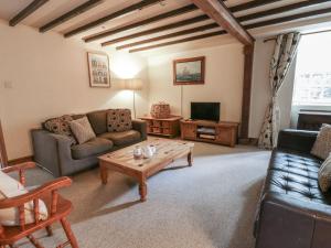 a living room with a couch and a coffee table at Dewi Villa Apartment in Aberaeron