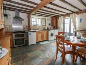a kitchen with a table and a stove and oven at Dewi Villa Apartment in Aberaeron
