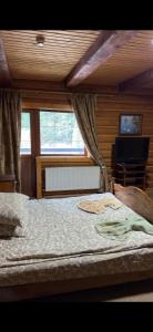a bedroom with a large bed in front of a window at Три підкови in Mykulychyn