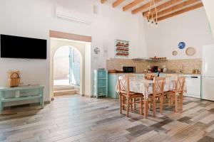 a kitchen and dining room with a table and chairs at Stefanis Relis House in Archangelos