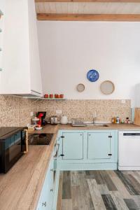 a kitchen with white cabinets and a sink at Stefanis Relis House in Archangelos