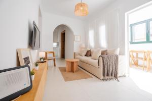 a white living room with a couch and a table at Avocado Corner House - Charco de San Gines By Lanzarote Vacation Homes in Arrecife