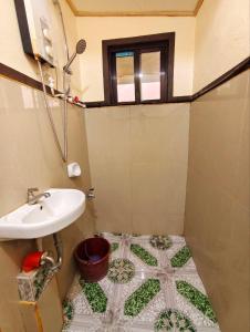 a bathroom with a sink and a toilet at Sagada Staycation with Mountain View! in Sagada +43 photos