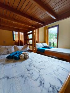 a bedroom with two large beds and a window at Sagada Staycation with Mountain View! in Sagada