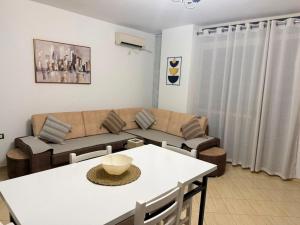 a living room with a white table and a couch at ASA Apartament in Tirana