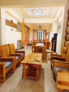 a living room with wooden furniture and a table at Sagada Staycation with Mountain View! in Sagada