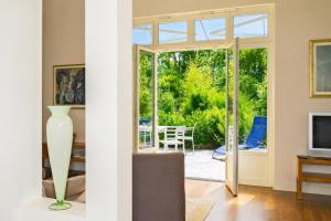 a living room with a sliding glass door leading to a patio at Landhaus Gernitz in Seedorf