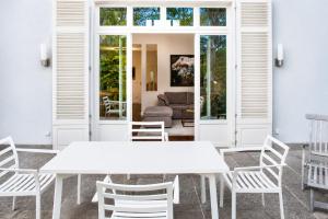 a white dining room with a white table and chairs at Landhaus Gernitz in Seedorf +16 photos