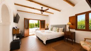 a bedroom with a bed and a television in it at Lemon Tree Retreat at El Amparo in Alhama de Granada