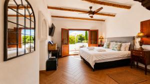 a bedroom with a bed and a large window at Lemon Tree Retreat at El Amparo in Alhama de Granada +89 photos