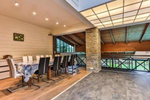a dining room with a table and chairs at L'atypique - Piscine intérieure - Wifi in Challans