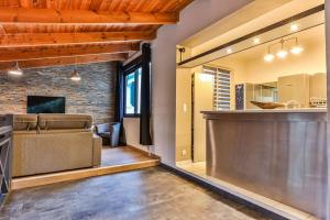 a kitchen and living room with a bar in a house at L'atypique - Piscine intérieure - Wifi in Challans +23 photos