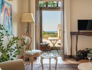 a living room with a view of the ocean at Borgo degli Ulivi - Castello di Montegridolfo in Montegridolfo