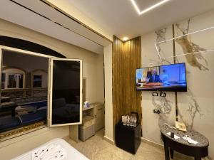 a hotel room with a tv on a wall at Pyramids Nun INN in Cairo
