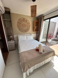 a bedroom with a large bed and a balcony at Casa Macao Pipa in Pipa
