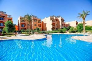 a large swimming pool in front of some buildings at La Hacienda Ras Sedr in Ras Matarma
