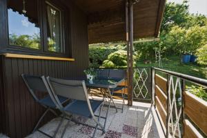 a patio with a table and chairs on a balcony at Apartment Vineyard nook Lendava in Lendava