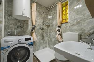 a bathroom with a washing machine and a sink at Apartment Vineyard nook Lendava in Lendava