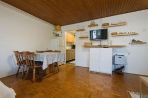 a kitchen with a table and a television in a room at Apartment Vineyard nook Lendava in Lendava +24 photos