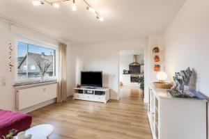 a living room with a large window and a television at Ferienwohnung Grübel in Kirchhundem