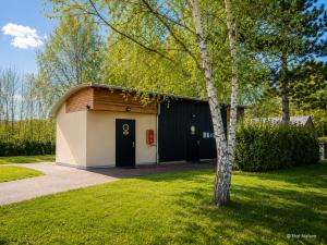 a garage with a tree in a yard at Bulle nuage - Etat Nature in Magnières +14 photos