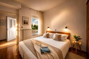 a bedroom with a large bed and a window at Terra Magica Deluxe Sea View Apartment or Room with Free Parking in Rijeka