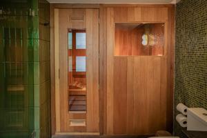 a bathroom with a wooden door in a bathroom at Maria Condesa Boutique in Mexico City +31 photos