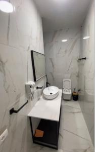 a white bathroom with a sink and a toilet at Villa Fibonacci - Beachfront Lalez Bay Durres in Draç +15 photos