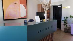 a reception desk in an office with a sign on it at Donners Hotell in Visby