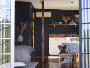 a bedroom with a bed and a white dresser at The Milkmans Shack in Dunorlan