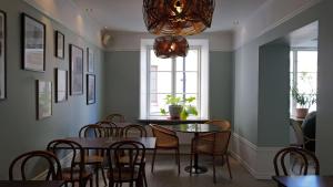 a dining room with a table and chairs and a chandelier at Donners Hotell in Visby +125 photos