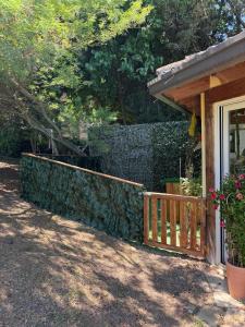 a stone fence next to a house with a porch at Blue Moon Relais in Santa Maria di Scacciano