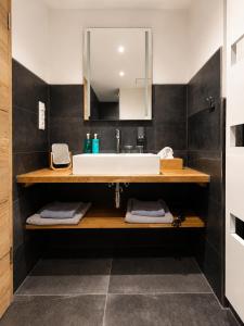 a bathroom with a sink and a mirror at Boutique Hotel Marielle in Bad Münstereifel +75 photos