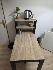 a wooden table with a tea kettle on top of it at Les Perriers in Chambray-lès-Tours
